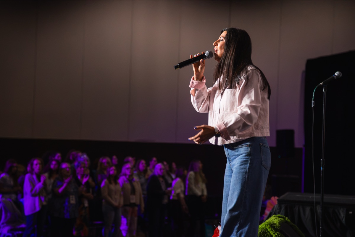 Worship leader singing with the MORE audience